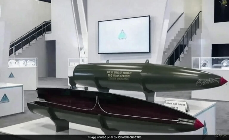 A sleek, cylindrical Mk 84 GAZAP thermobaric fragmentation bomb, painted in dark military green, is showcased on a display stand at IDEF 2025 in Istanbul. The 2.6-meter-long bomb features four stabilizing tailfins and a polished metallic nose, with the Turkish flag and "GAZAP" branding visible on its side. The background includes a crowded exhibition hall with defense equipment and banners.
