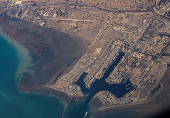 Oil tankers sailing through the Strait of Hormuz as regional conflict disrupts Iraq’s crude exports and global energy supply.